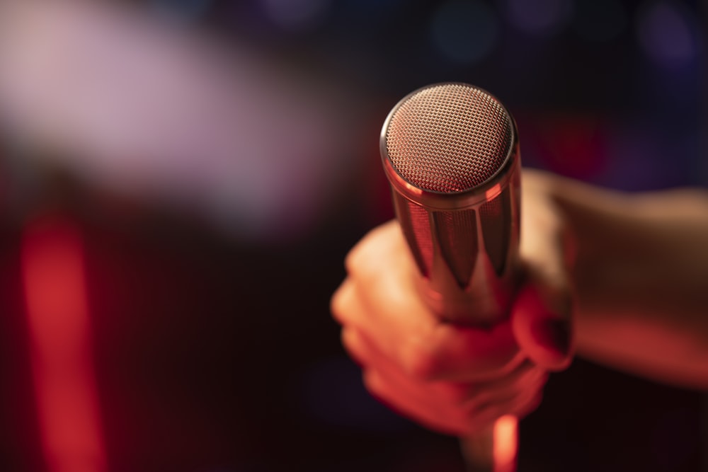 a close up of a person holding a microphone