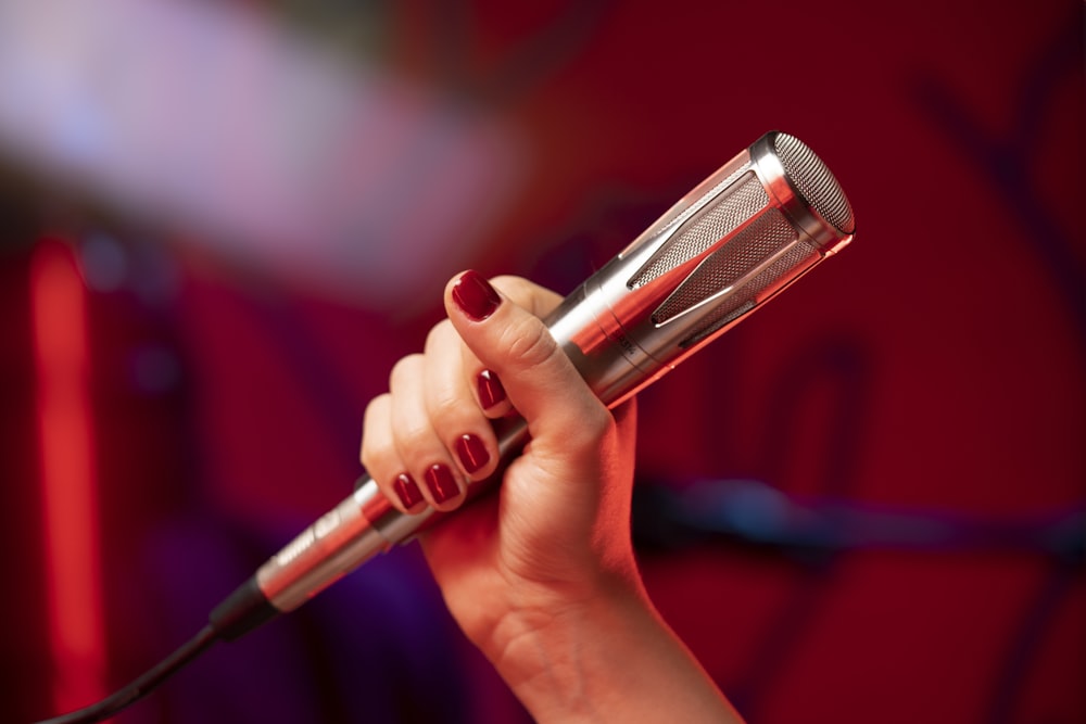 a woman holding a hair dryer in her hand