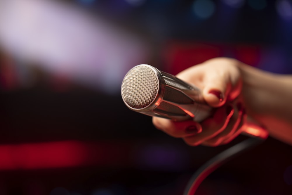a close up of a person holding a microphone