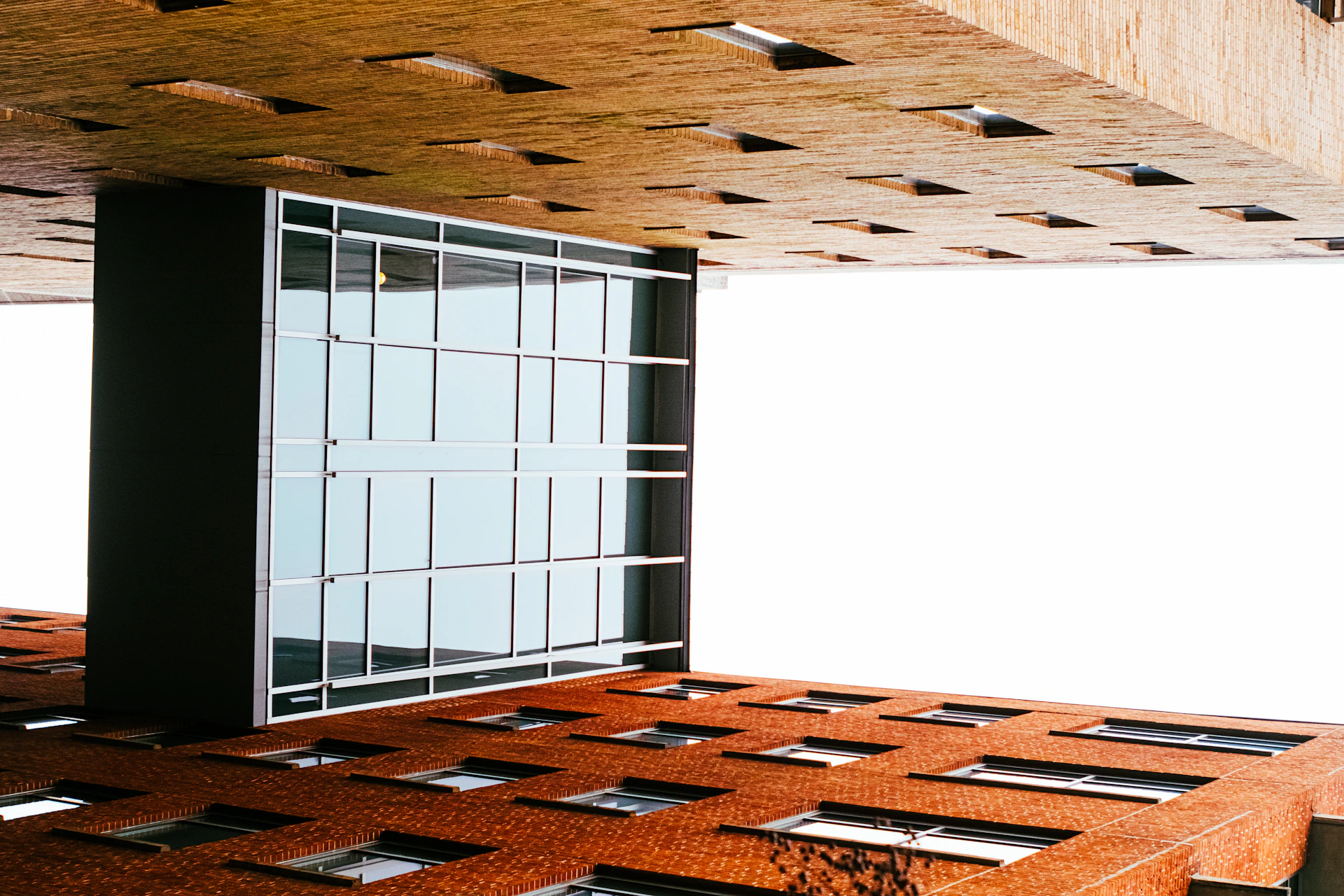 a room with a large window and a brick floor