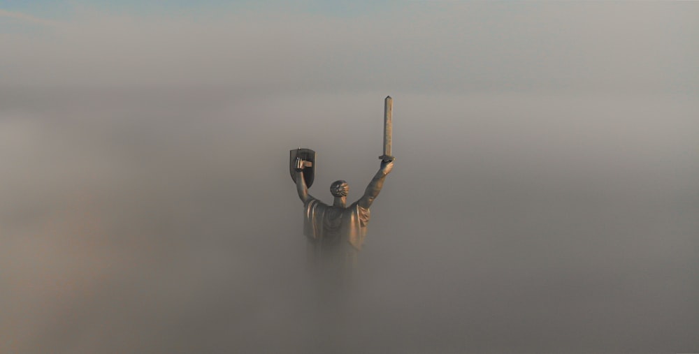 a statue in the middle of a body of water