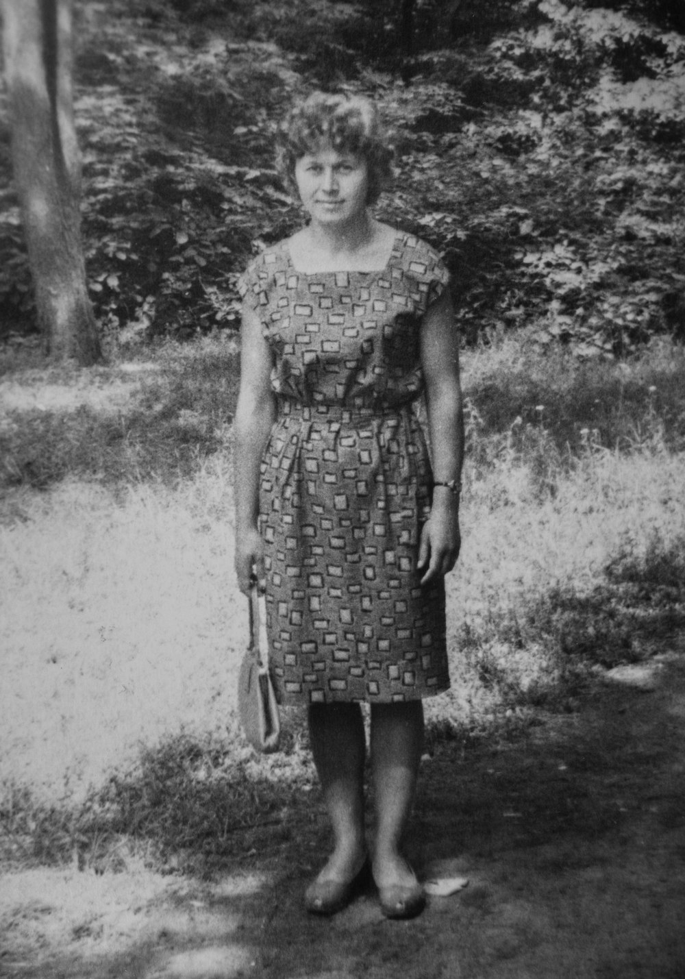 an old photo of a woman in a dress