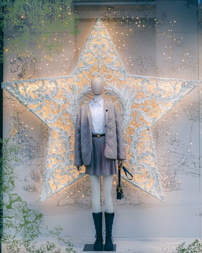 Elegant school uniform displayed on a mannequin against a soft beige background with ochre red accents