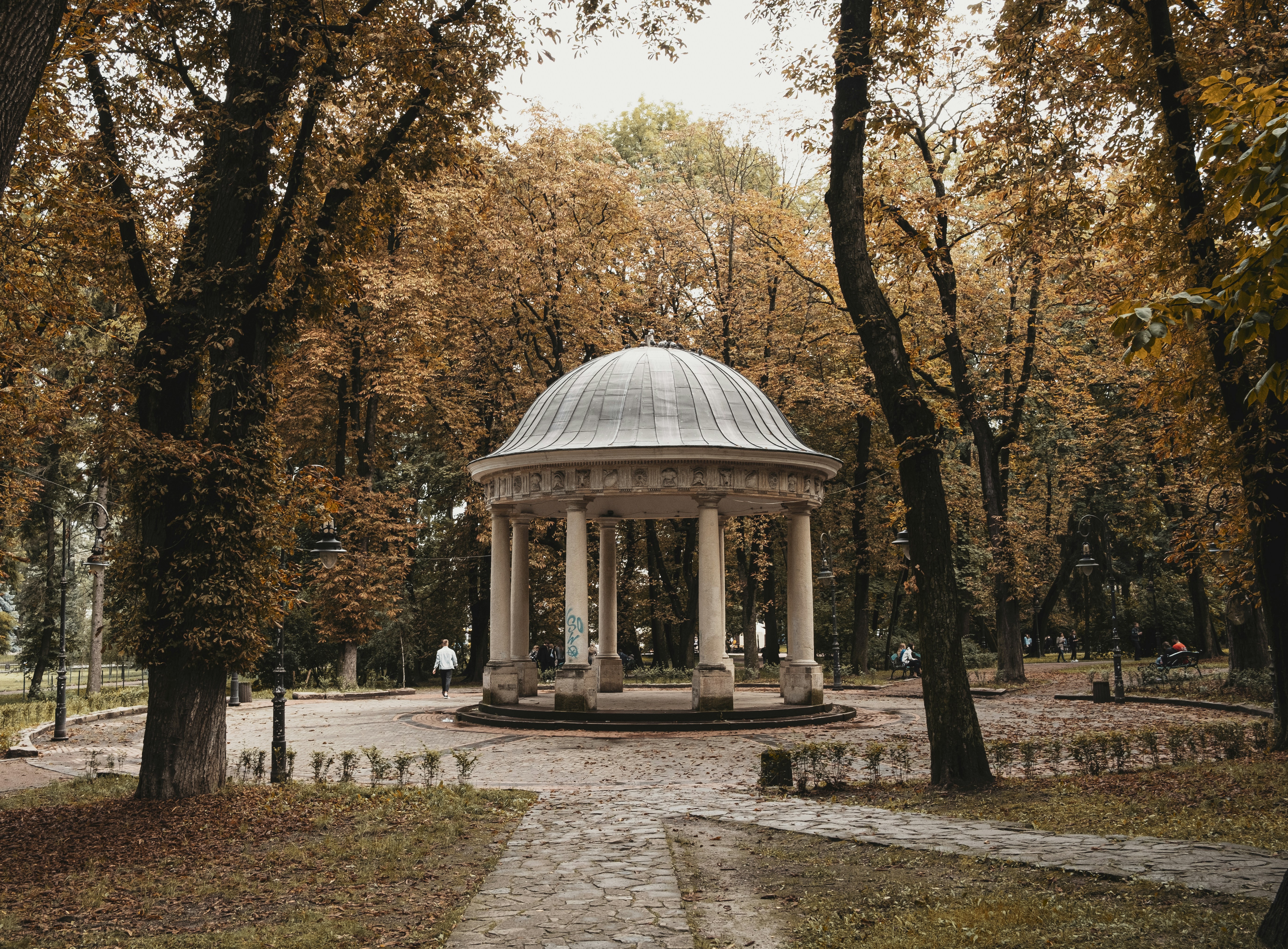 a gazebo in a park surrounded by trees