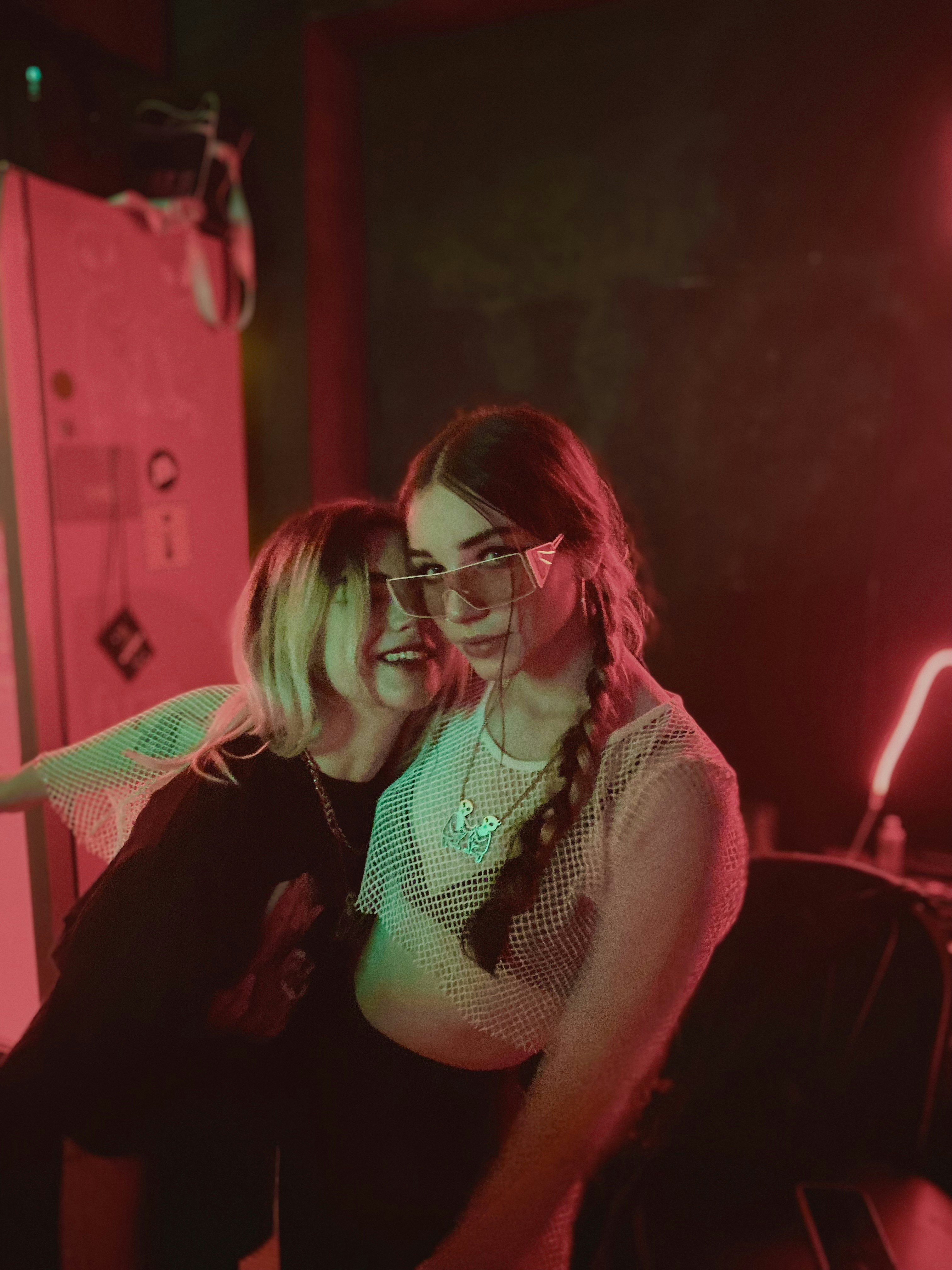 two young women sitting next to each other in a room