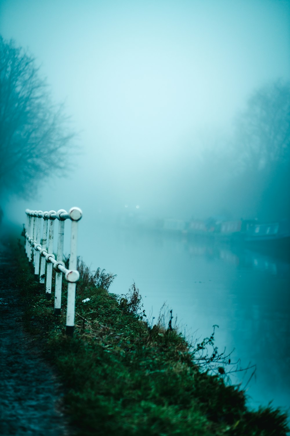 a row of benches sitting next to a body of water