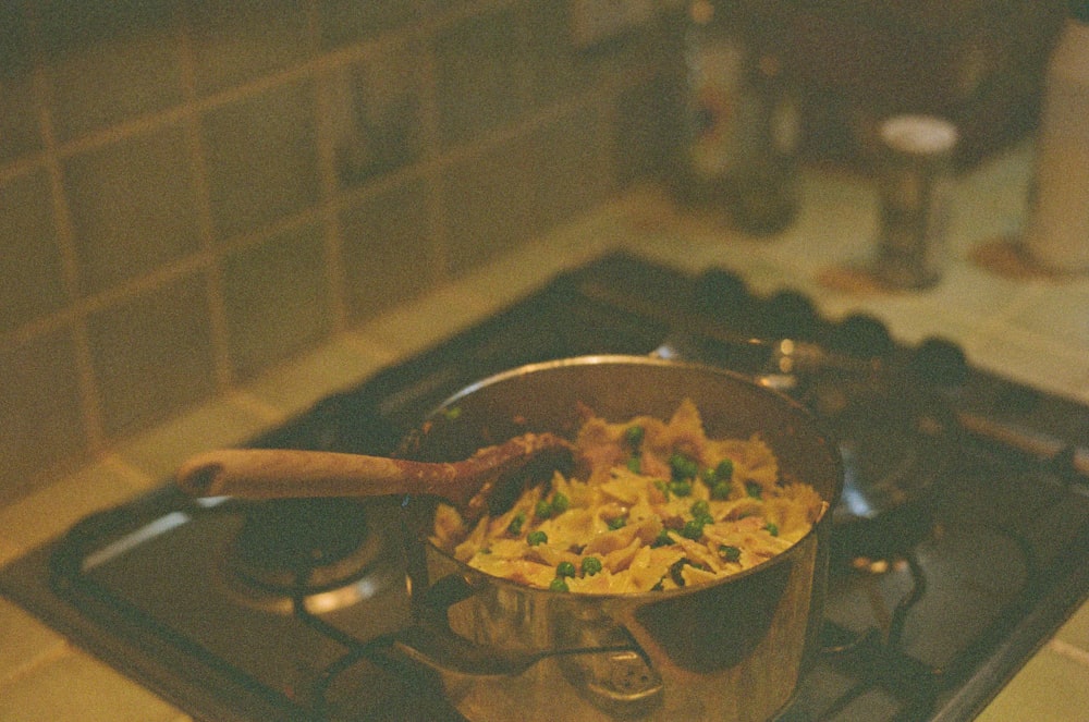 a pan filled with food sitting on top of a stove