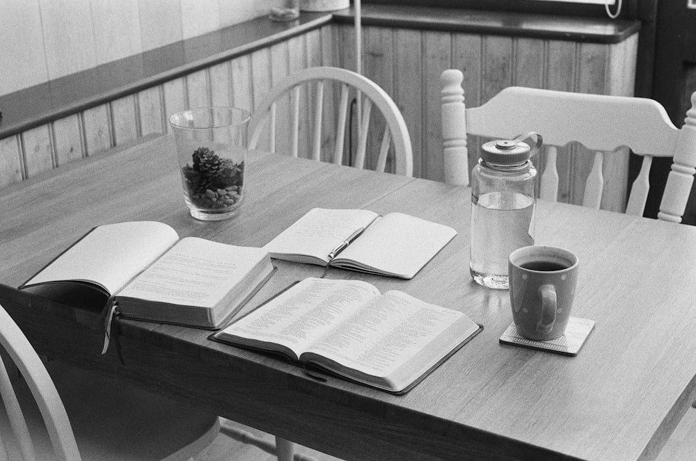 a wooden table topped with a book and a cup of coffee