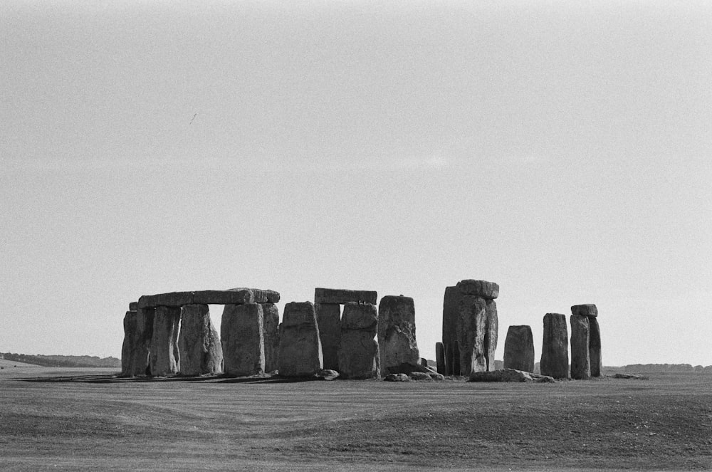 a black and white photo of stonehenge in a field
