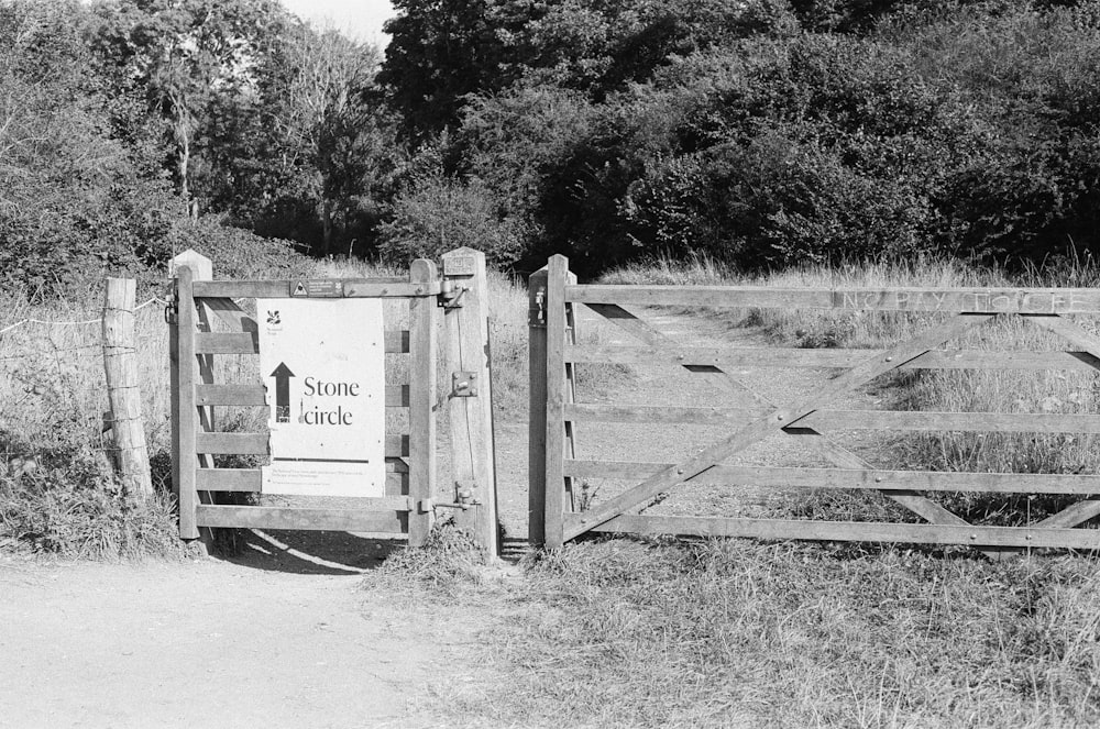 a black and white photo of a wooden gate