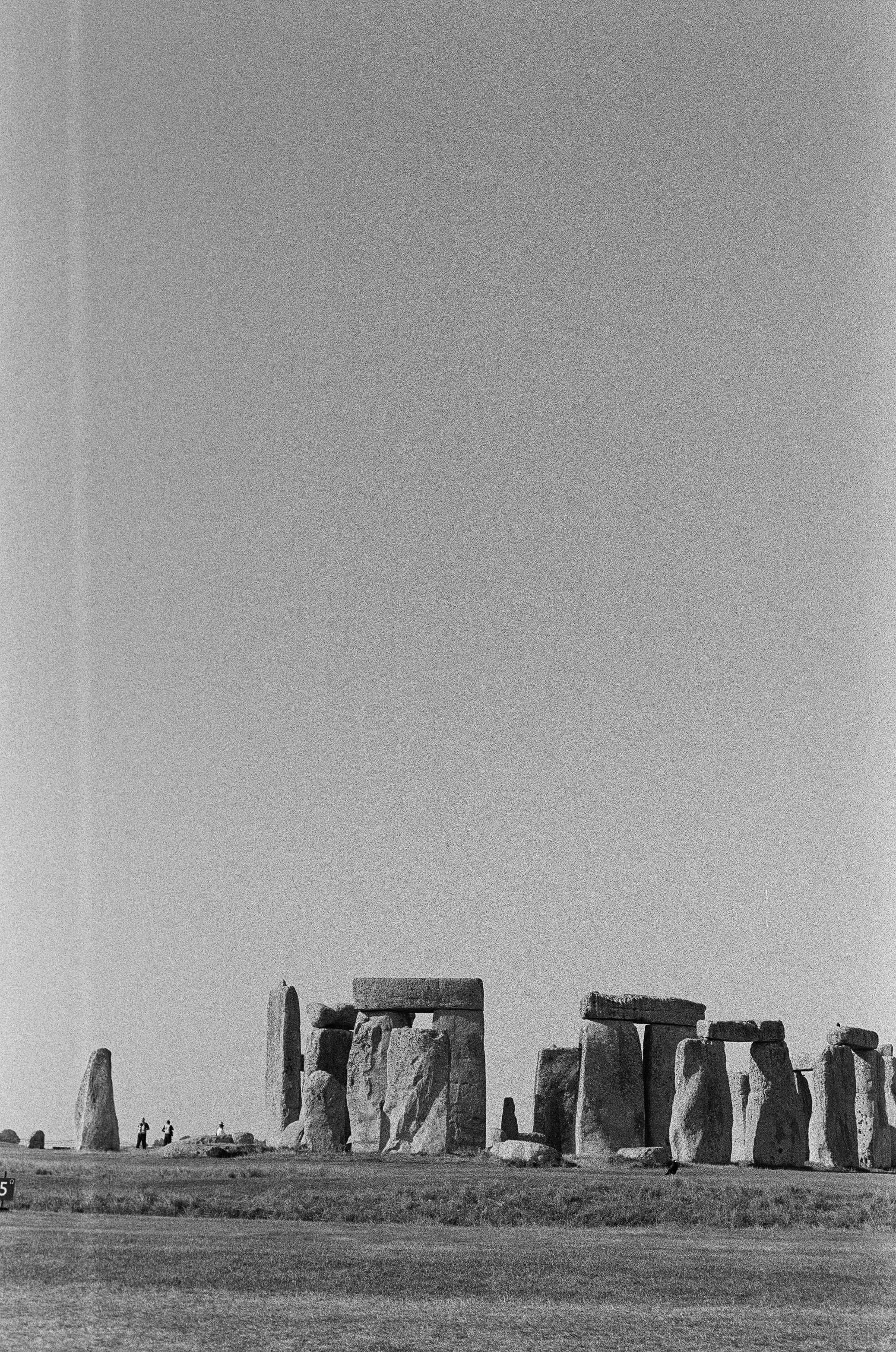 a black and white photo of stonehenge in the desert