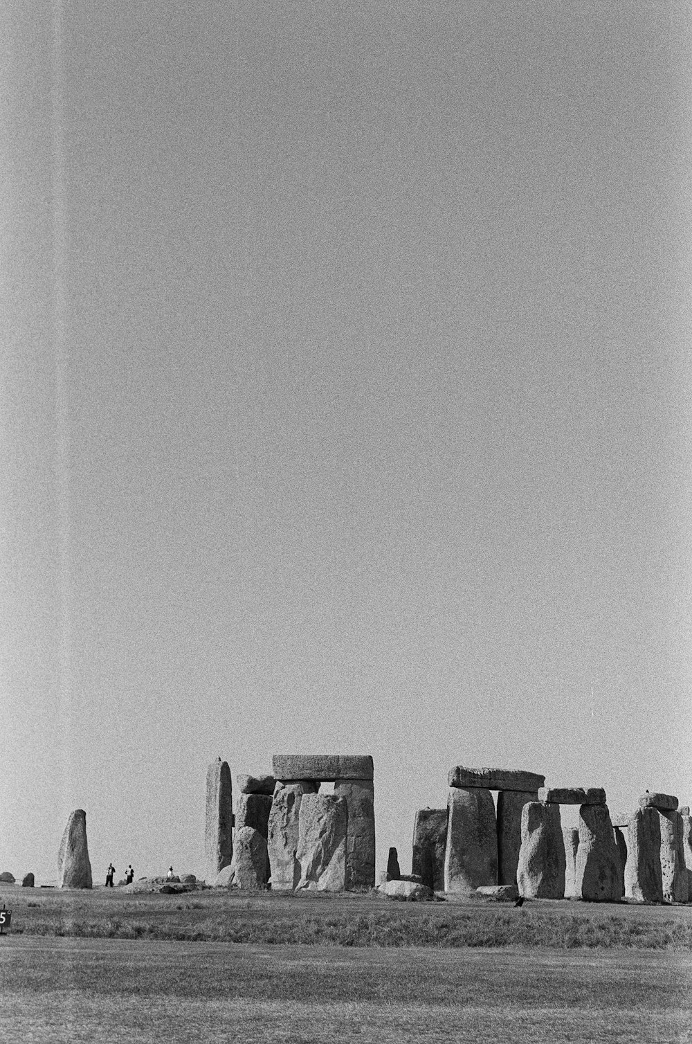 a black and white photo of stonehenge in the desert