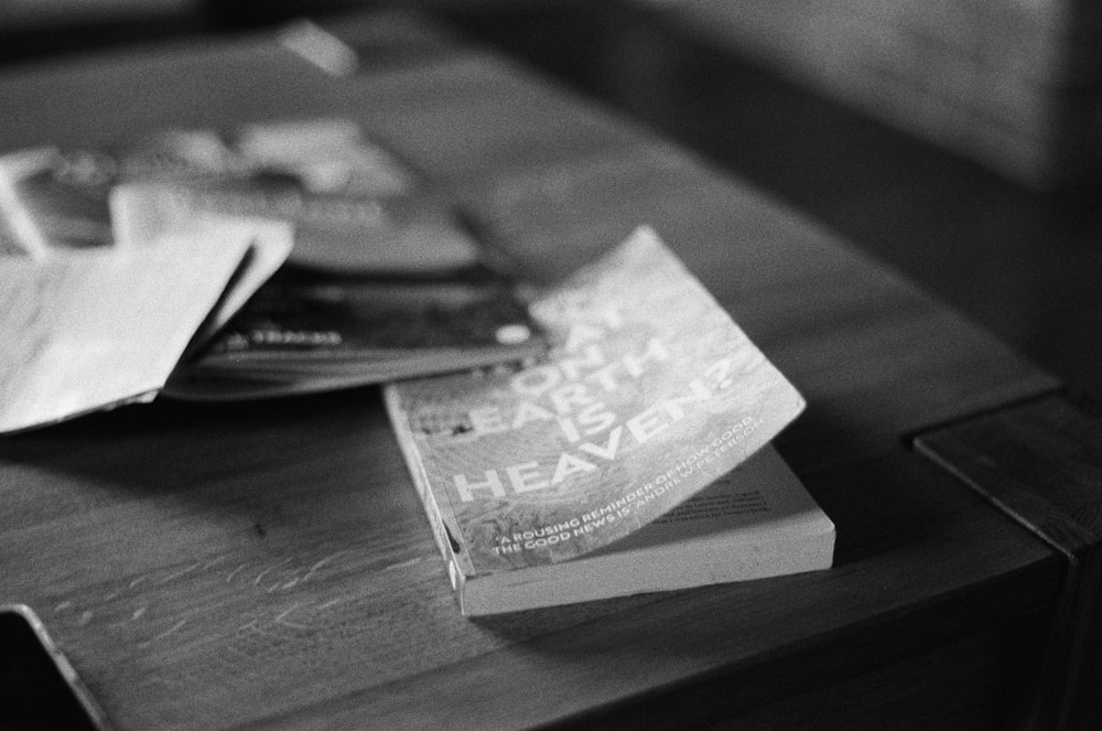 a wooden table topped with lots of papers