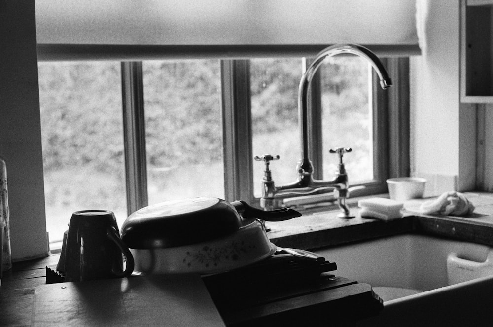 a black and white photo of a kitchen sink