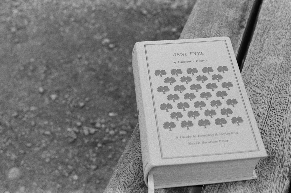 a book sitting on top of a wooden bench