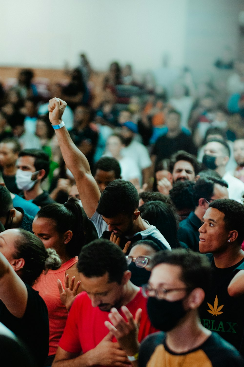 a large crowd of people wearing face masks