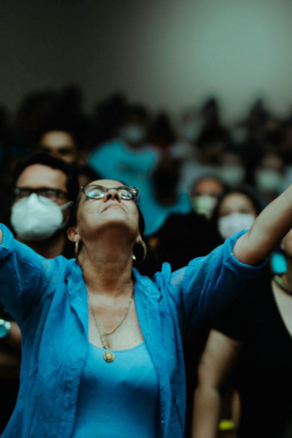 a woman wearing a face mask in a crowd of people