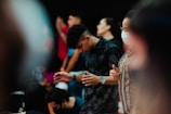 A group of people gathered around a table during a spiritual ceremony, showing focus and devotion.