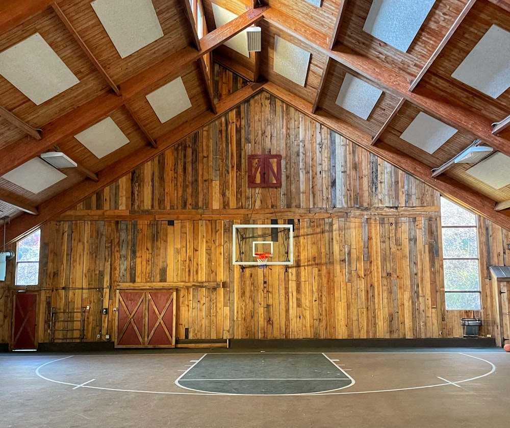 a basketball court inside of a wooden building