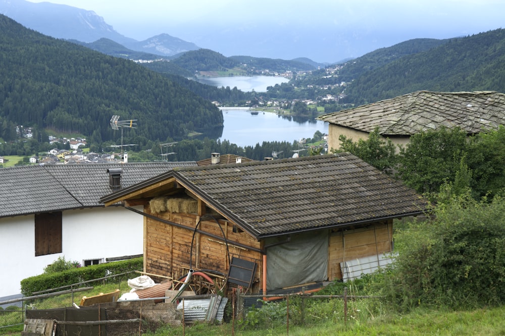 a house on a hill with a lake in the background