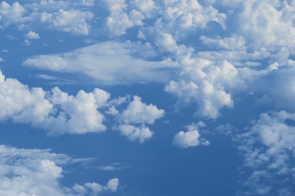 a blue sky filled with lots of white clouds