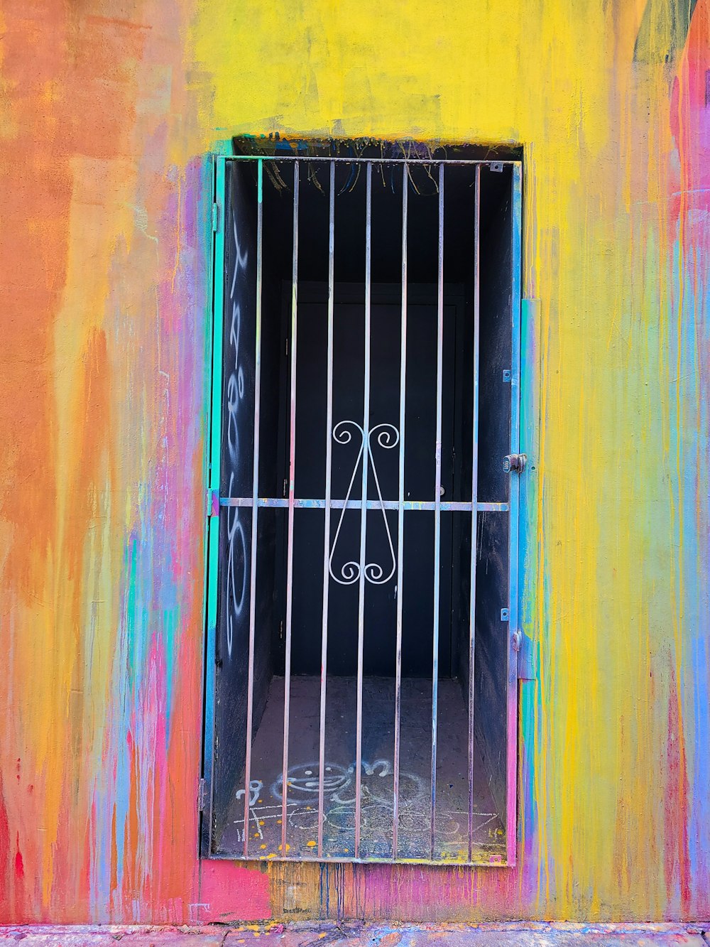 a barred window on a colorful wall with bars