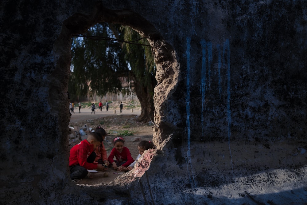 a group of people sitting in a cave