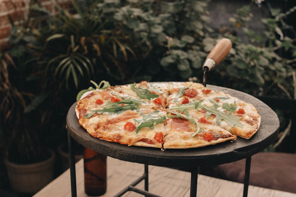 a pizza sitting on top of a black table