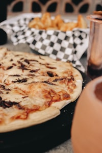 a pizza sitting on top of a pan on top of a table