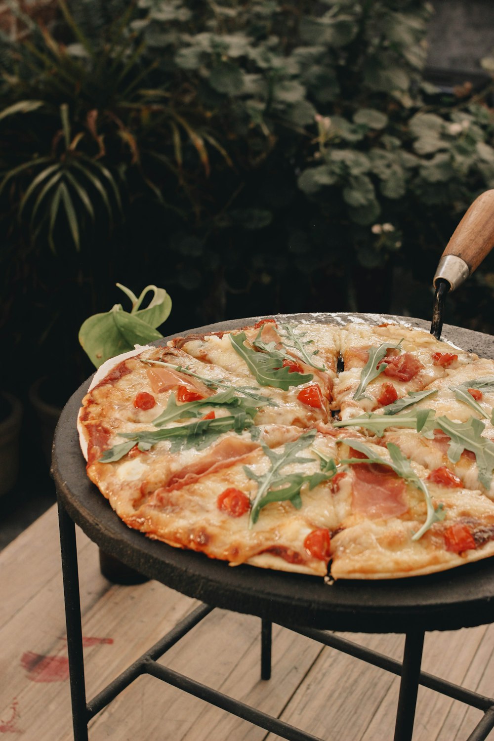 a pizza sitting on top of a wooden table