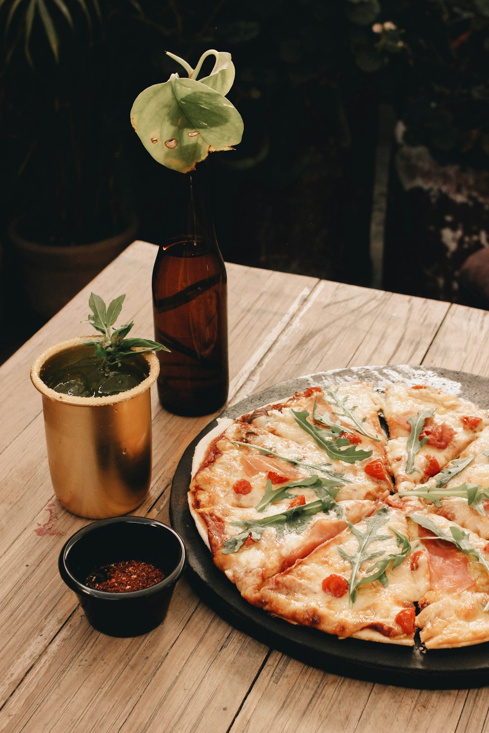 a pizza sitting on top of a pan on top of a wooden table