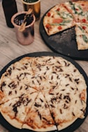 a couple of pizzas sitting on top of a table