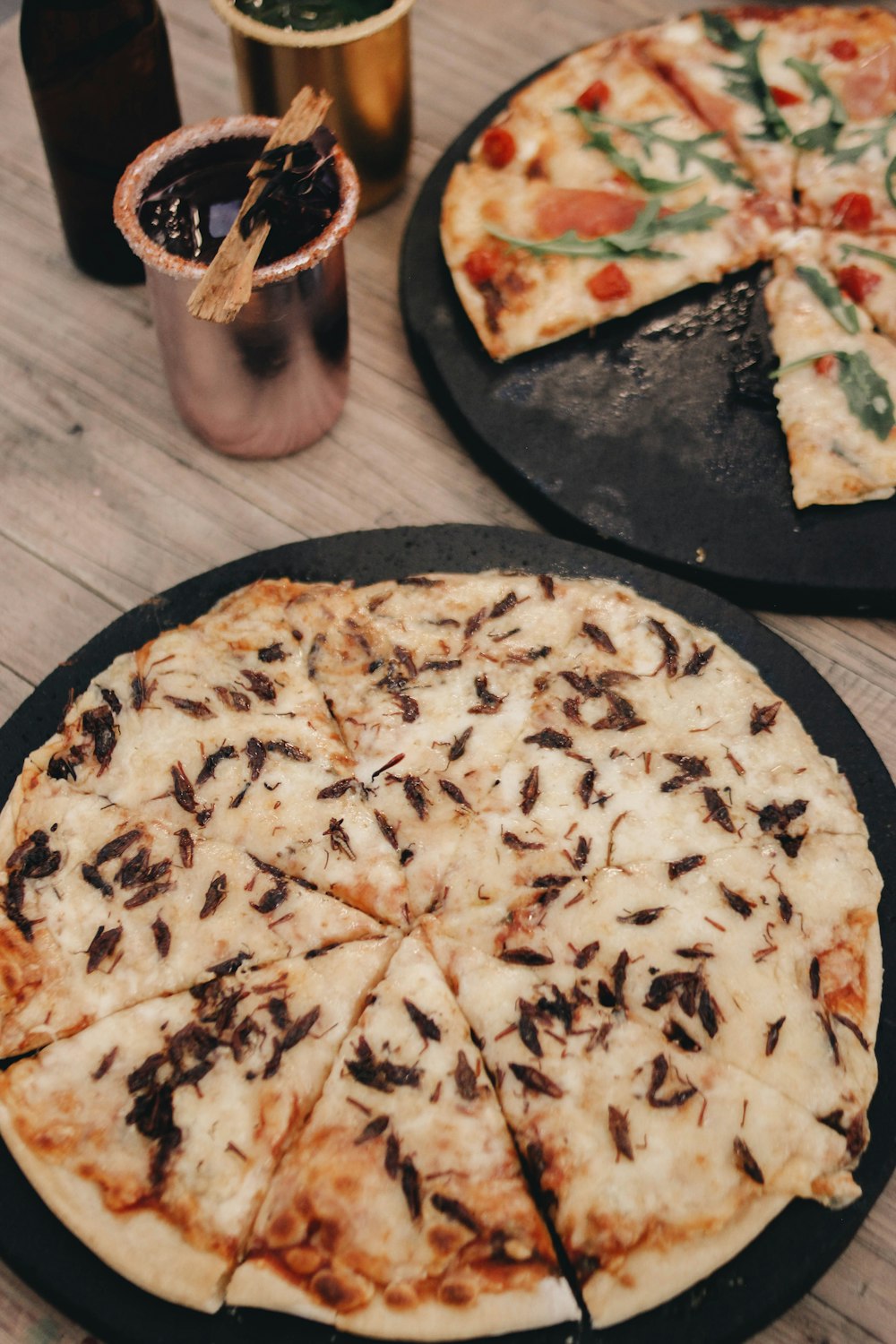 a couple of pizzas sitting on top of a table