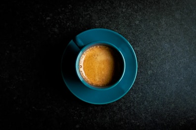 Artisan coffee cups with rich crema on a navy blue tablecloth