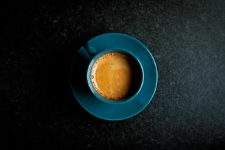 Artisan coffee cups with rich crema on a navy blue tablecloth