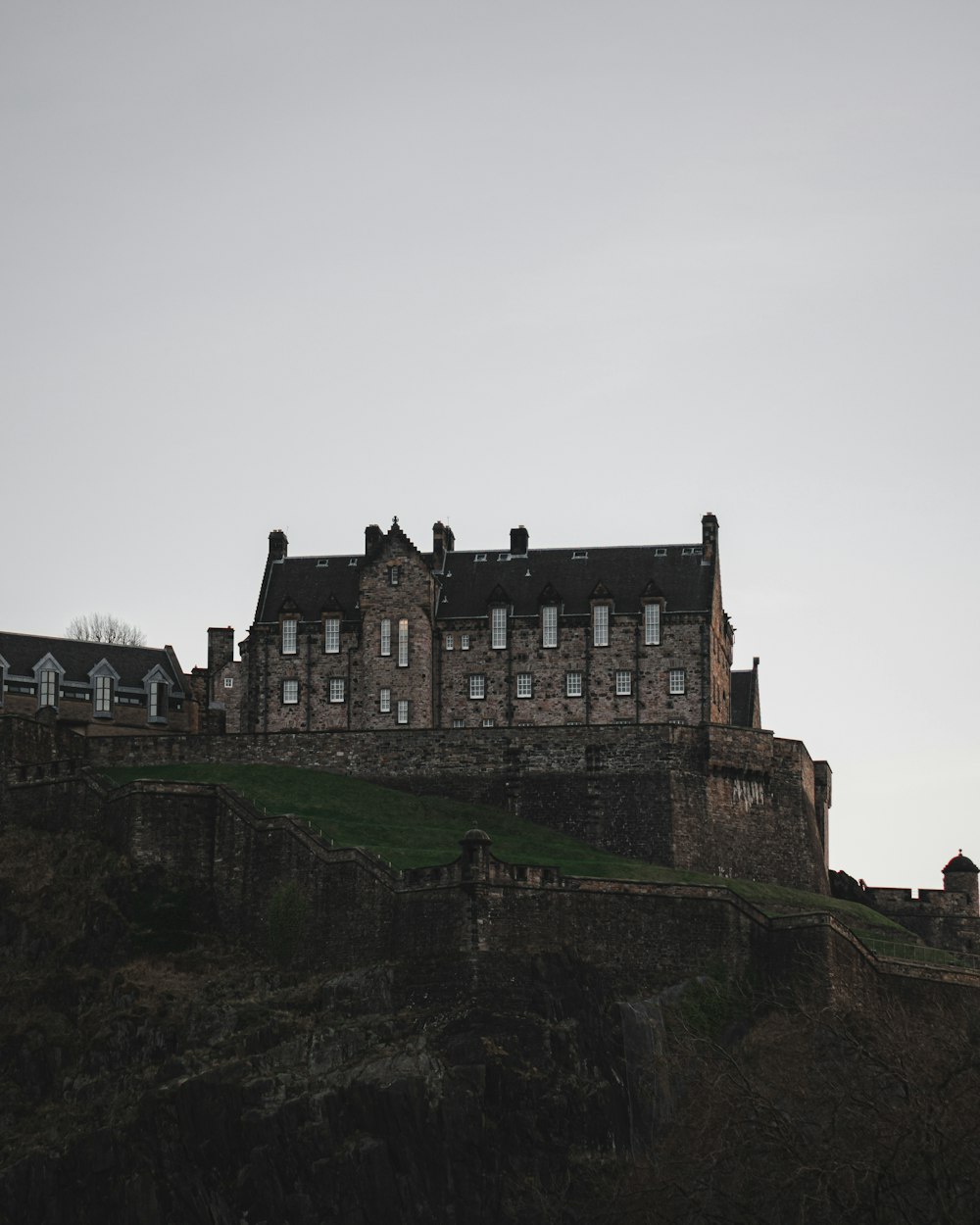 a castle on top of a hill with a sky background