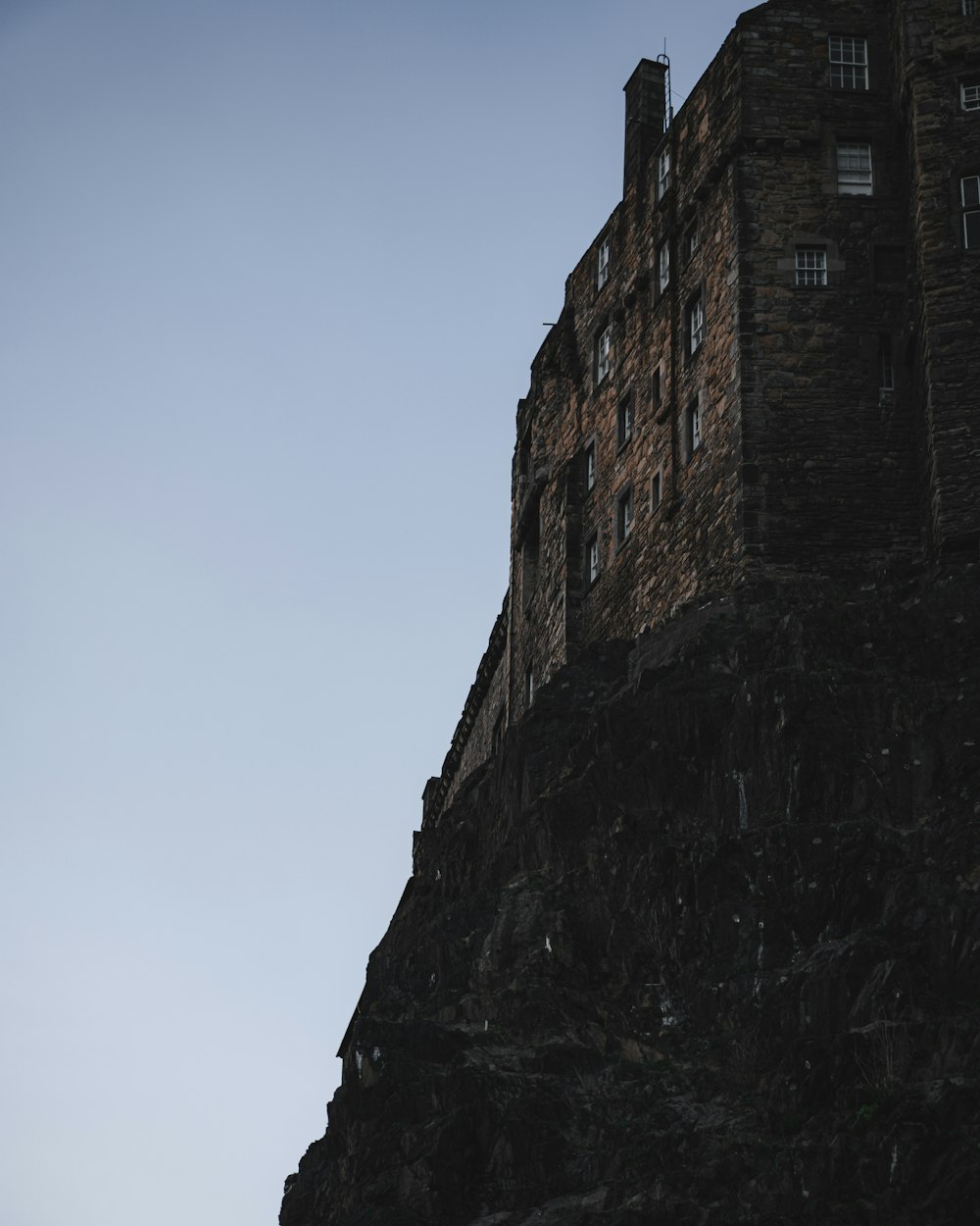 a tall brick building sitting on the side of a mountain