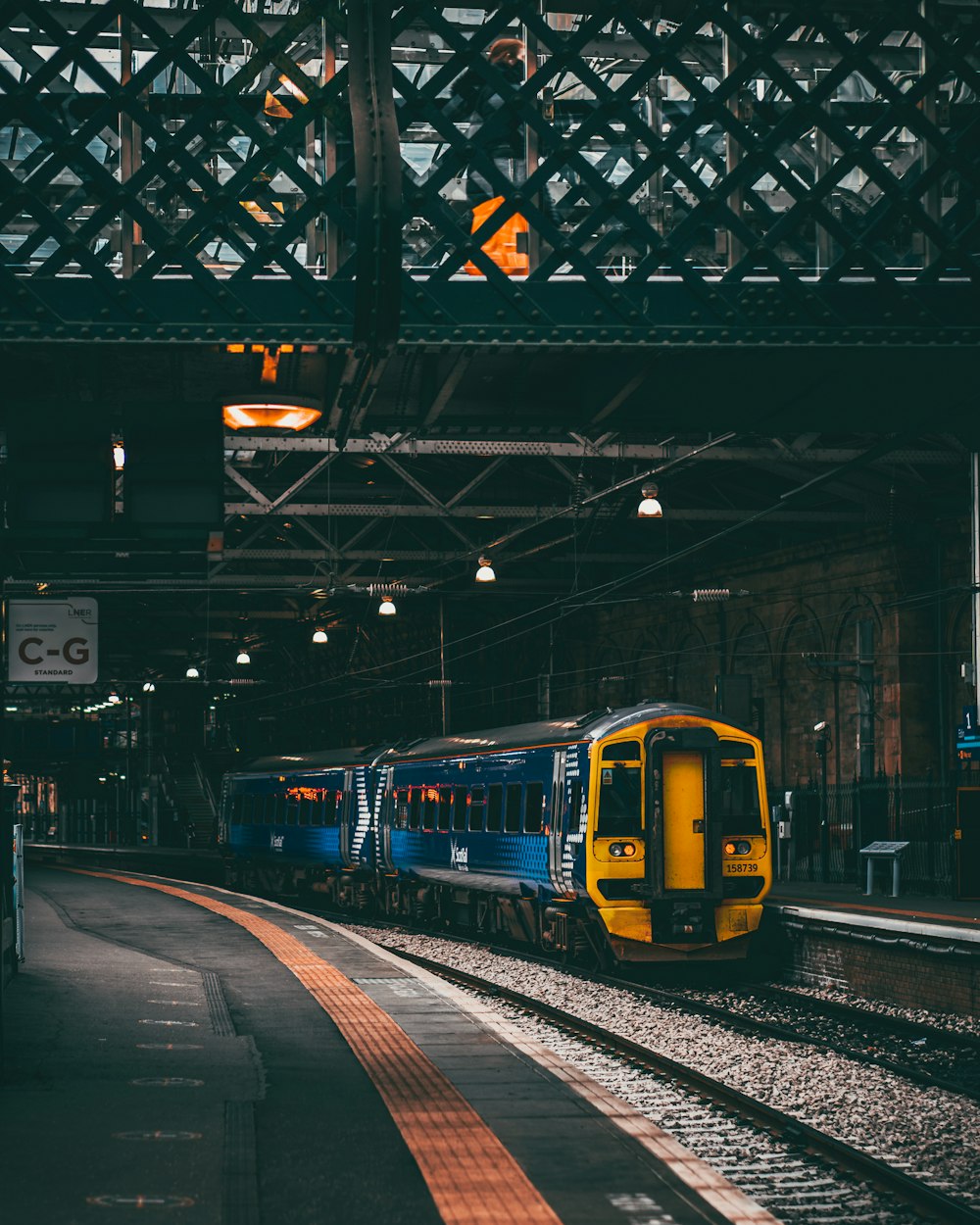 a yellow and blue train traveling down train tracks