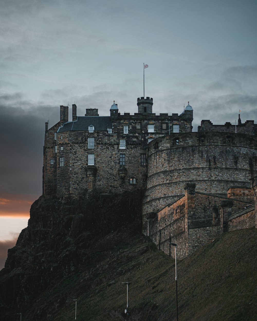 a castle on a hill with a flag on top of it