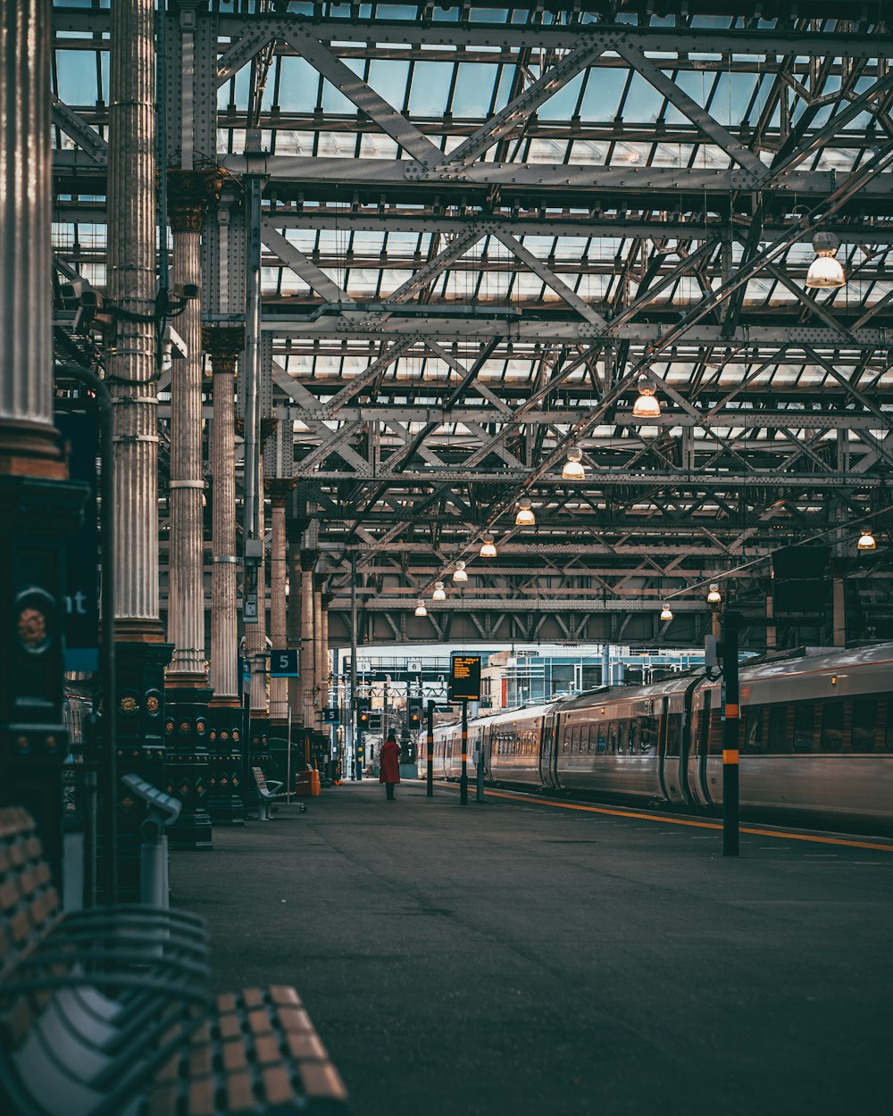 a train pulling into a train station next to a platform