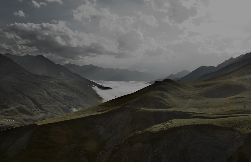 a view of a valley with mountains in the background