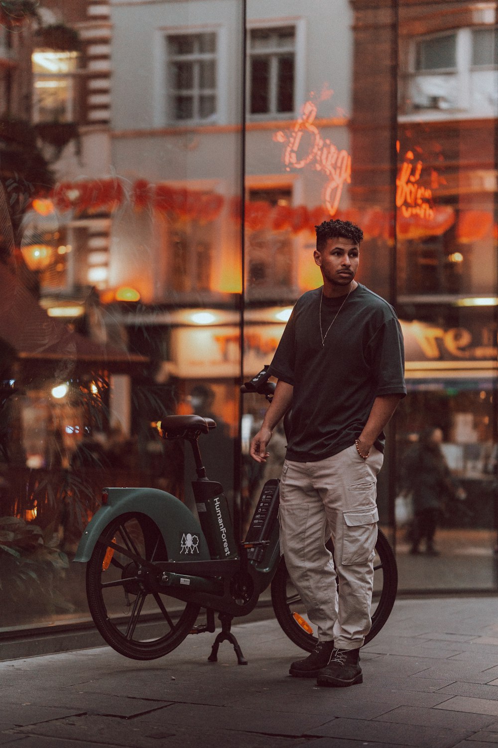 a man standing next to a scooter on a city street