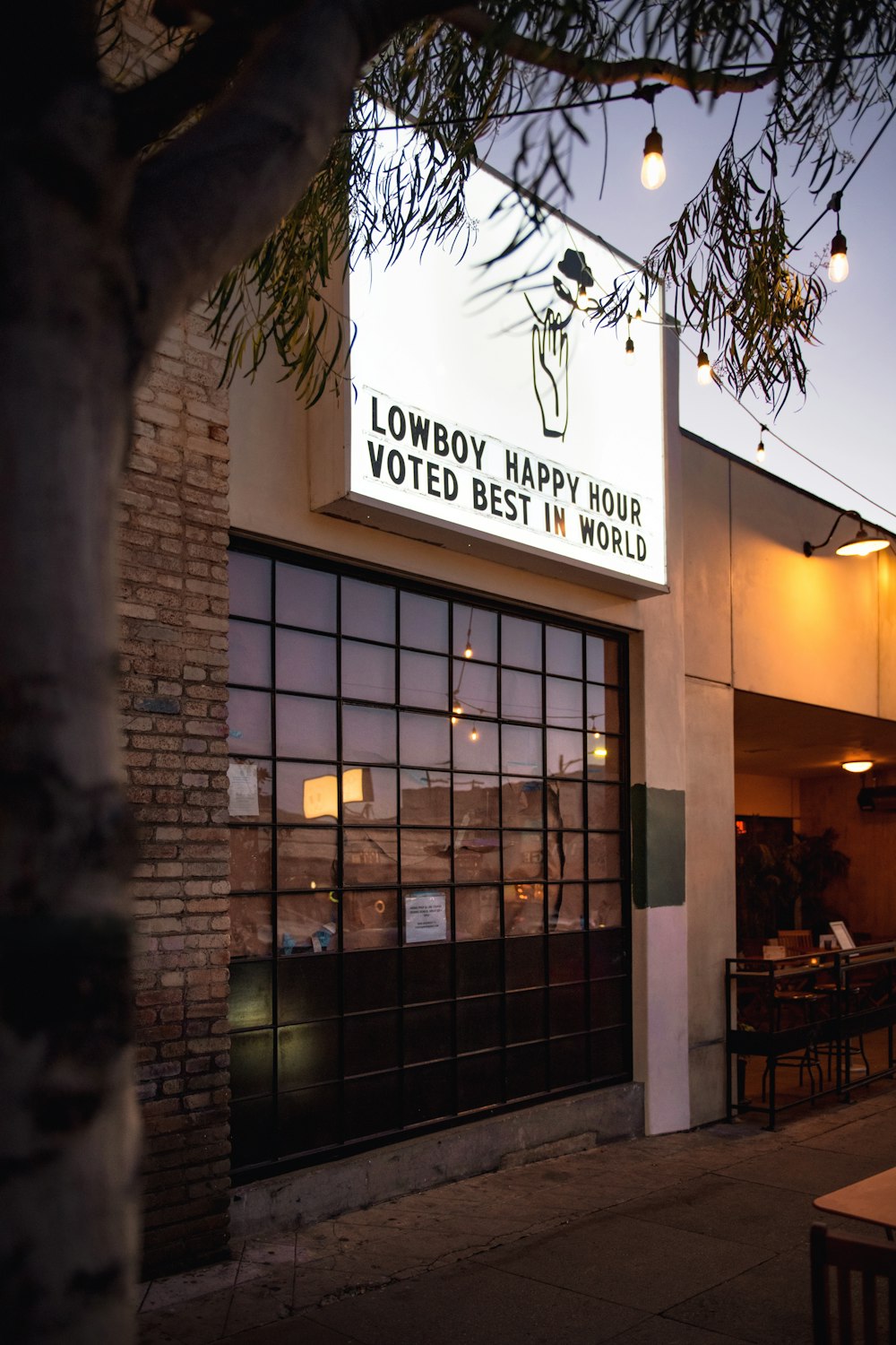 a building with a sign that says lowboy happy hour voting best in world