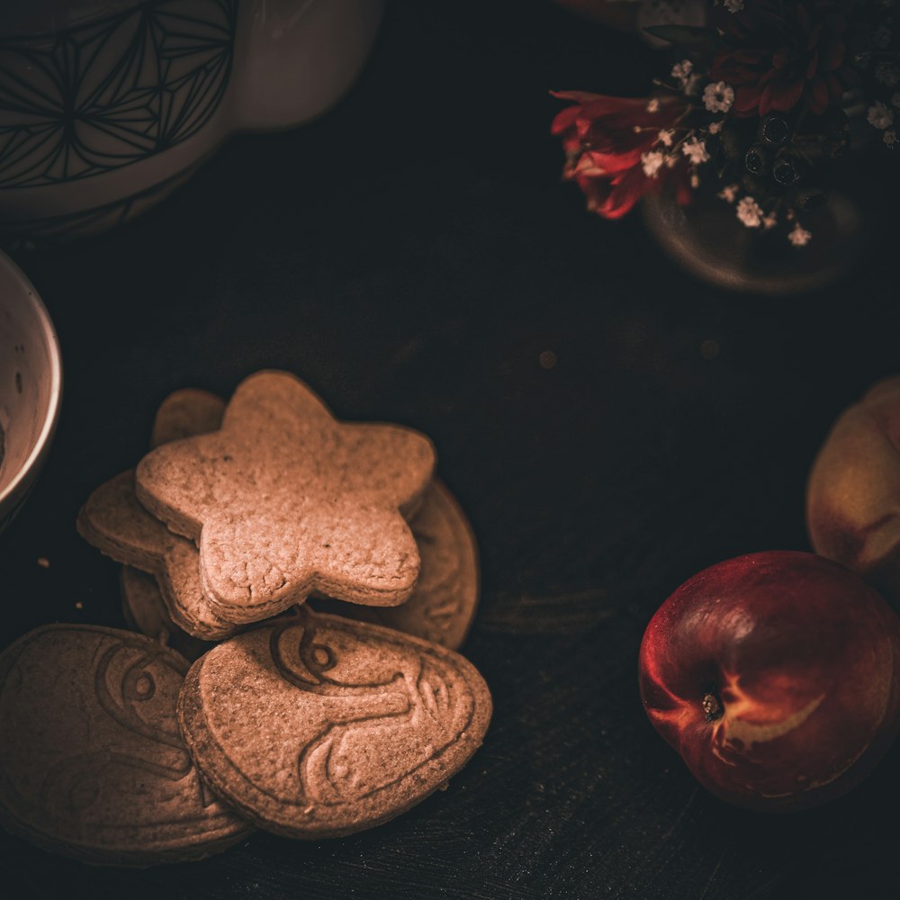 a table topped with cookies and apples