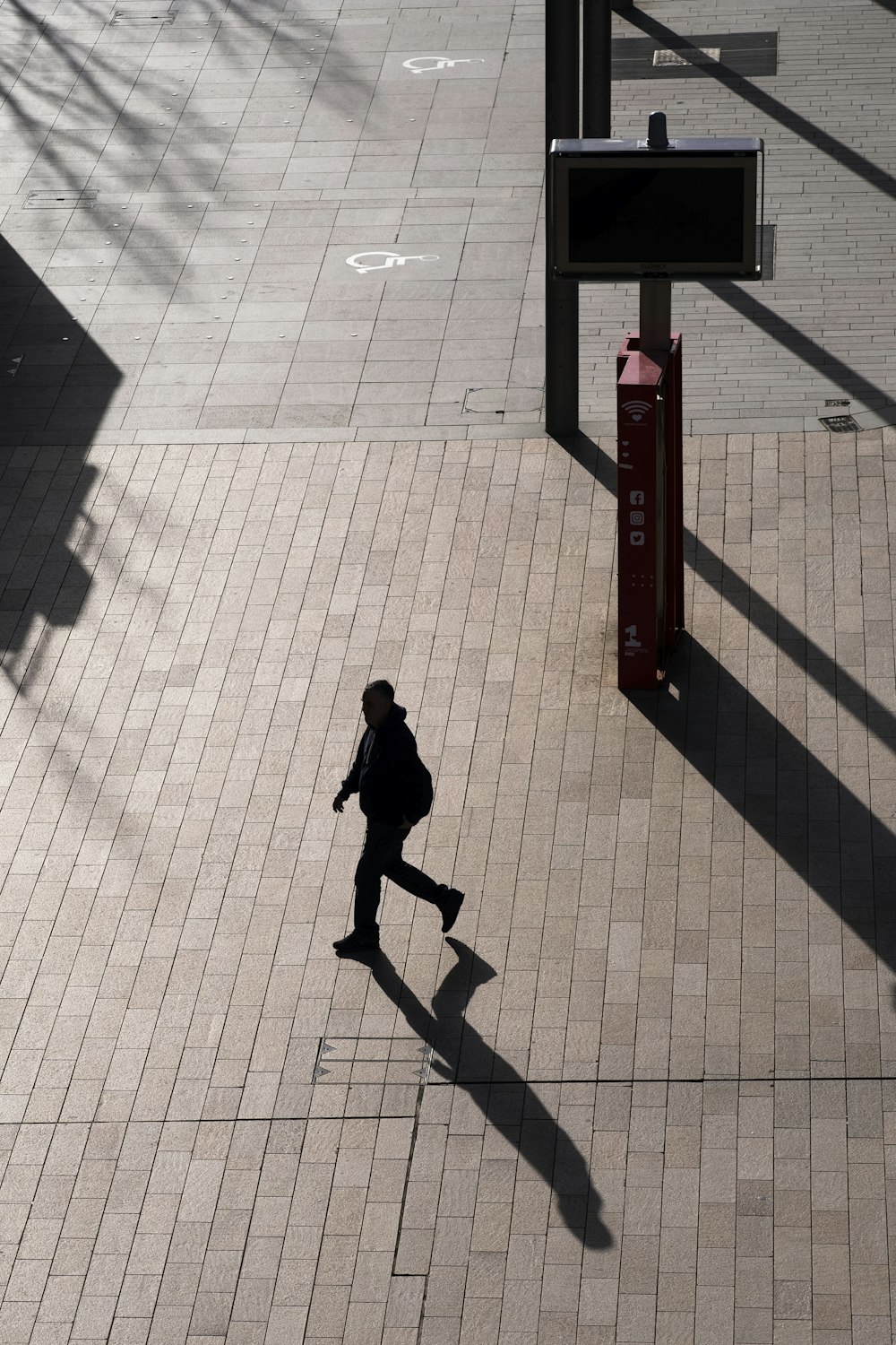 a person walking down a sidewalk with a backpack