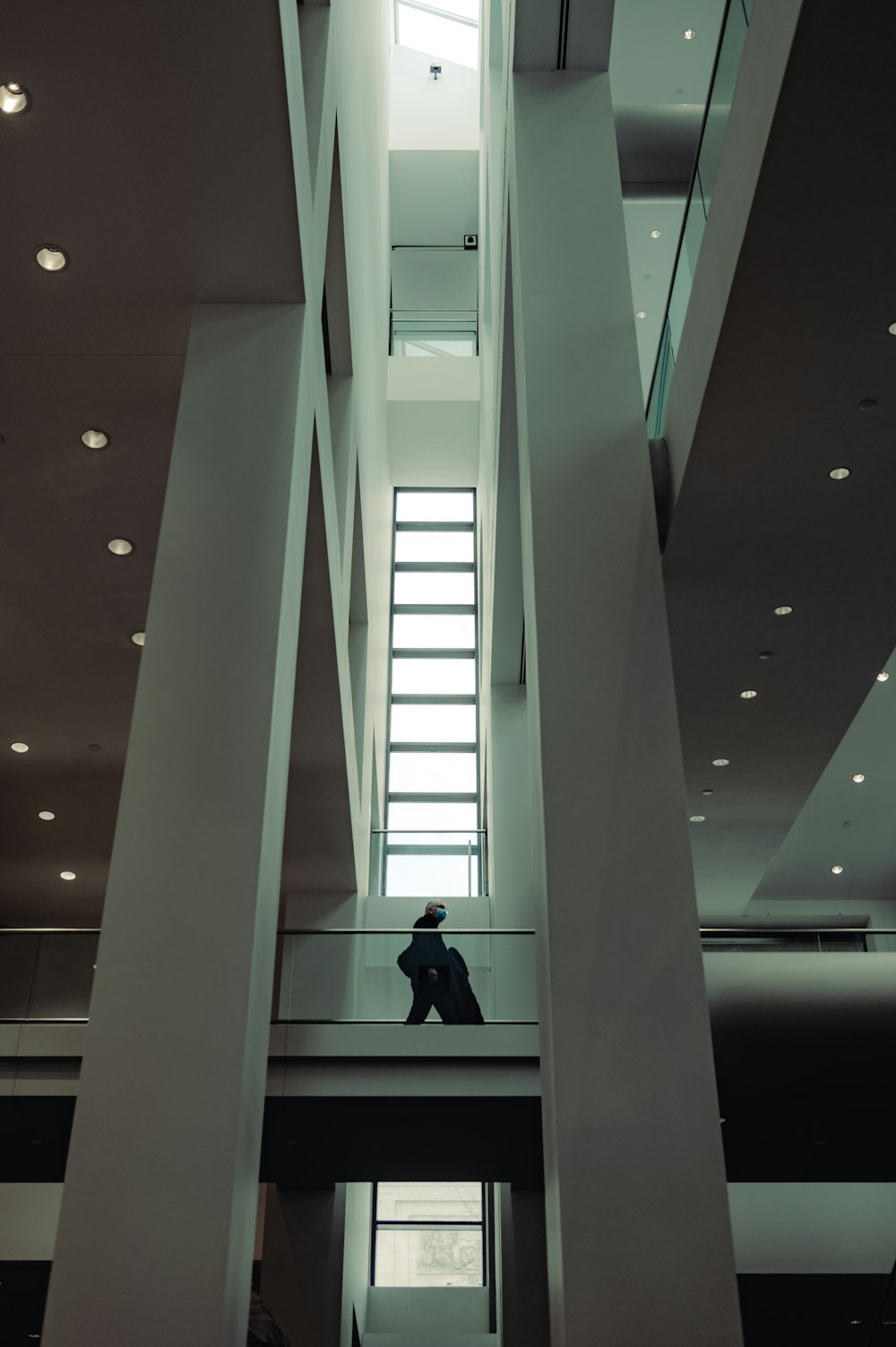 a person sitting on a ledge in a building