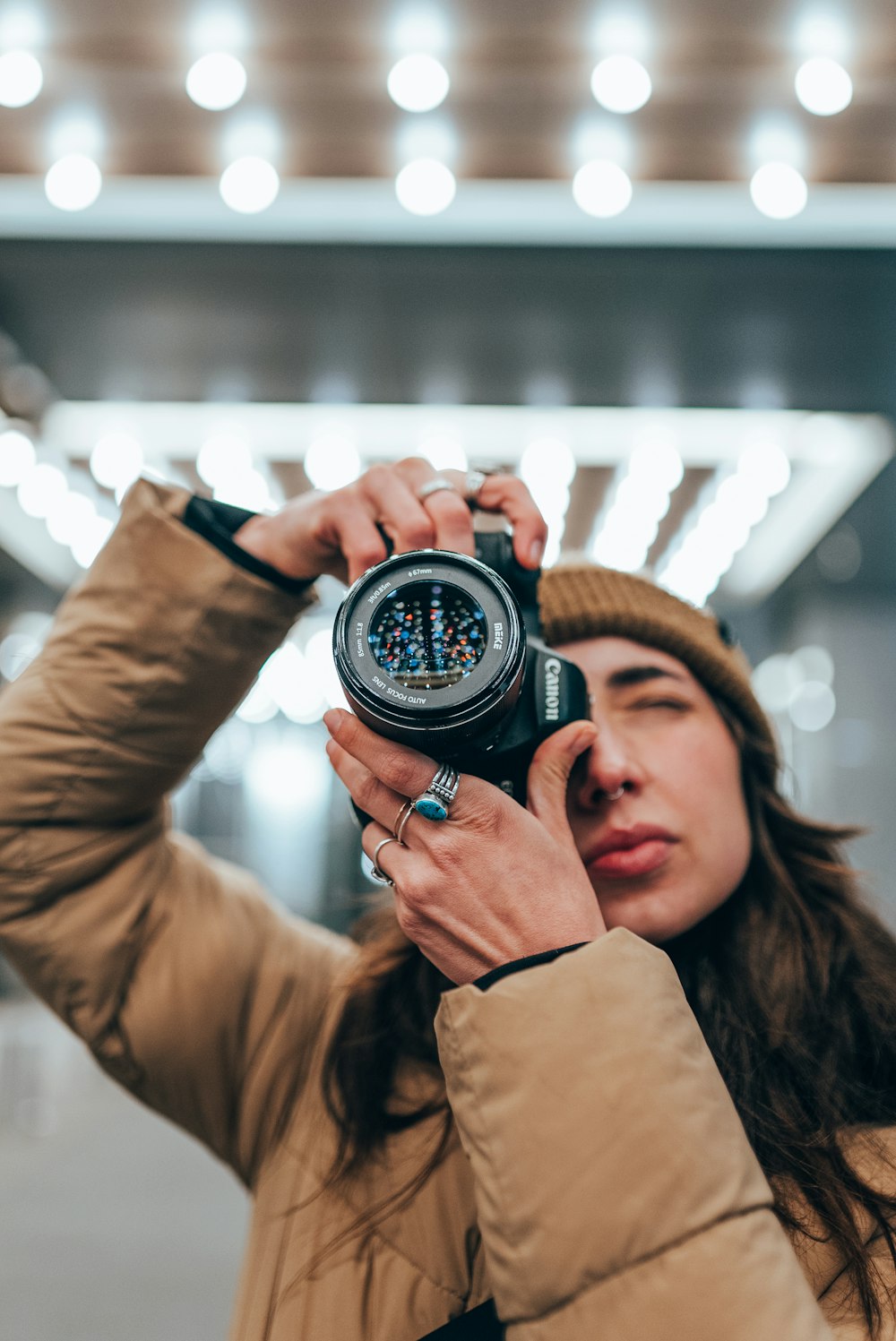 a woman taking a picture of herself with a camera