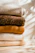 A cozy wool sweater displayed on a rustic wooden table with soft natural light.