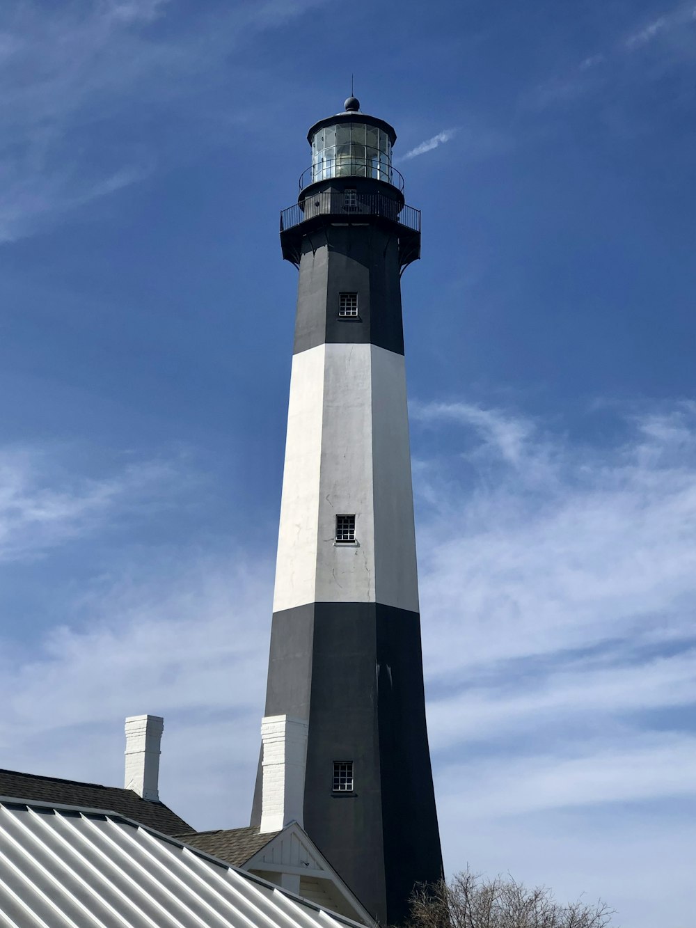 a black and white lighthouse on a clear day