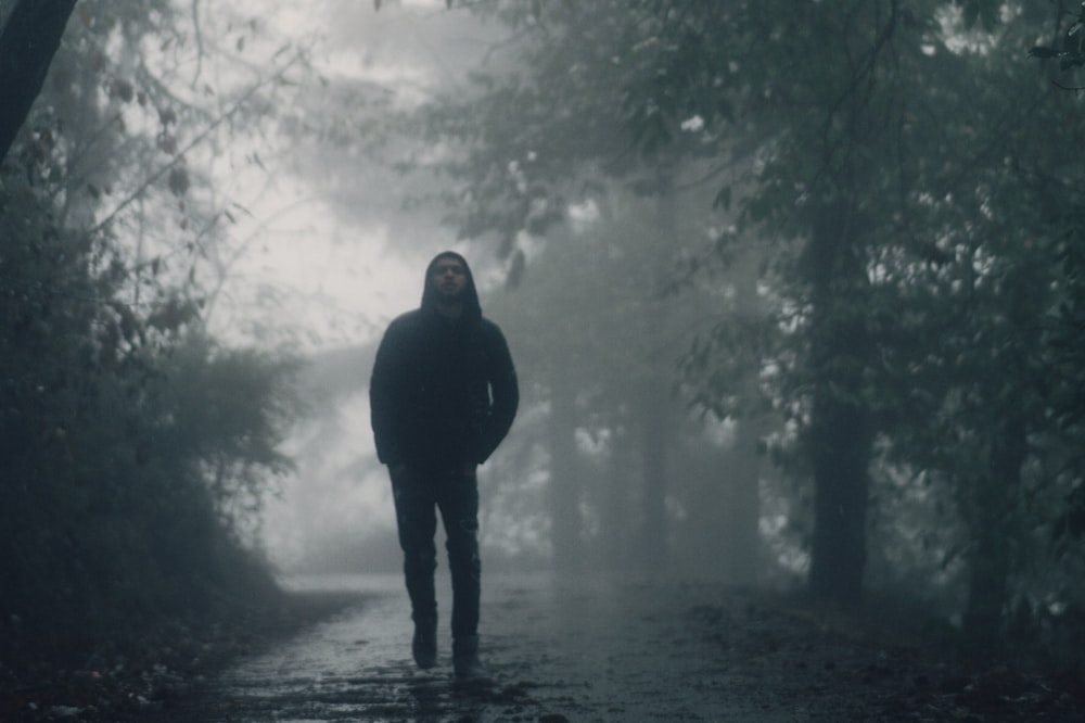 a man standing in the middle of a forest